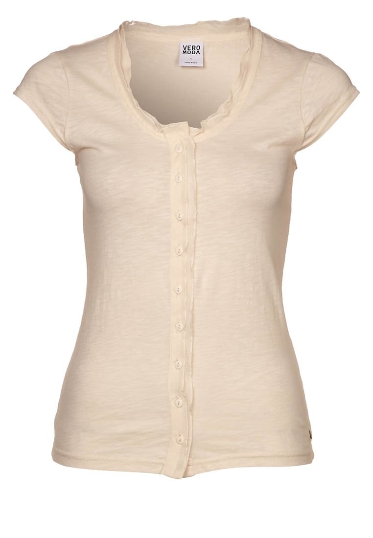 Beige kortärmad skjorta med rund halsringning, med en volangkant och en rad knappar fram. Mjuk, lätt tyg.