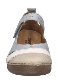 Light blue leather shoe with a white accent and beige toe. Mary Jane style with a single adjustable strap. Flat, rounded sole. Smooth texture.