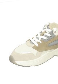Light beige and gray sneakers with a mix of textured materials, including suede and mesh, featuring white laces and a chunky rubber sole.