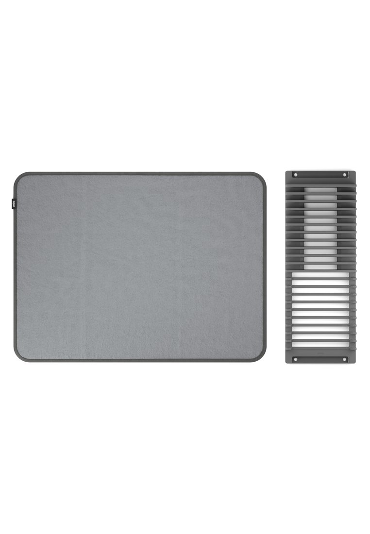 Graue rechteckige Matte mit abgerundeten Ecken, die eine glatte Textur aufweist, neben einem grauen Lüftungsgitter mit horizontalen Lamellen.