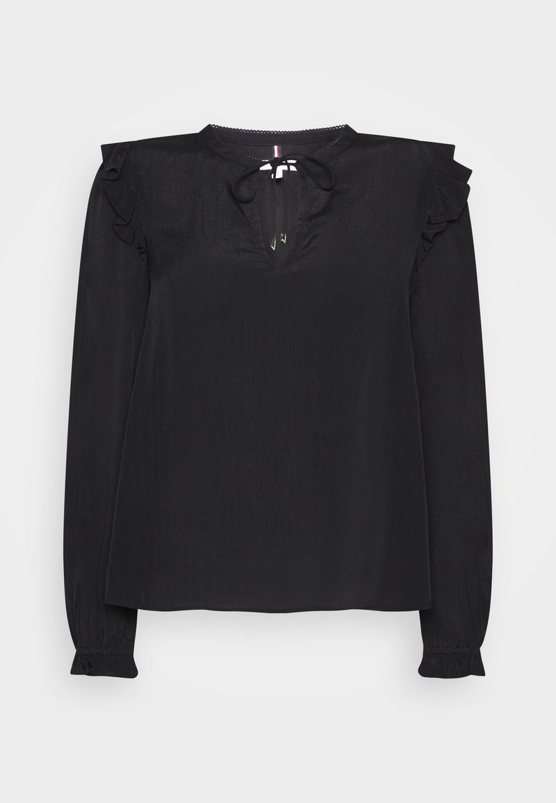 Blusa nera a maniche lunghe con scollo a V, dettagli arricciati sulle spalle e sui polsini. Realizzata in un tessuto leggero e morbido. Design minimalista.