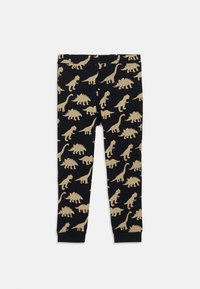 Schwarze Leggings mit einem sich wiederholenden tanfarbenen Dinosauriermuster. Aus weichem Material gefertigt, mit einem elastischen Bund und enganliegendem Design.