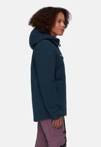 Navy blue waterproof jacket with a hood, zippered front, and adjustable cuffs. Features a minimalist design and soft texture.