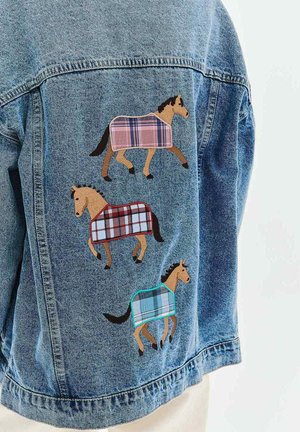 Kurtka jeansowa z trzema wyszywanymi końmi, noszącymi kratkowane koce w kolorach różowym, czerwonym i niebieskim na plecach.