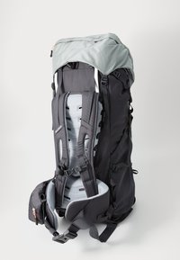 Black backpack with a light gray top. Features padded shoulder straps and hip belt, adjustable buckles, and a textured fabric pattern.