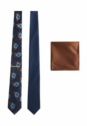 Two neckties—one navy with blue flowers and brown leaves, one blue with orange dots—and a folded brown pocket square.