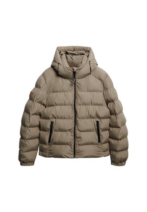 Pufferjack in tan met een capuchon. Voorzien van horizontale stiksels, een rits aan de voorkant en twee ritszakken aan de zijkant. Getextureerde afwerking.