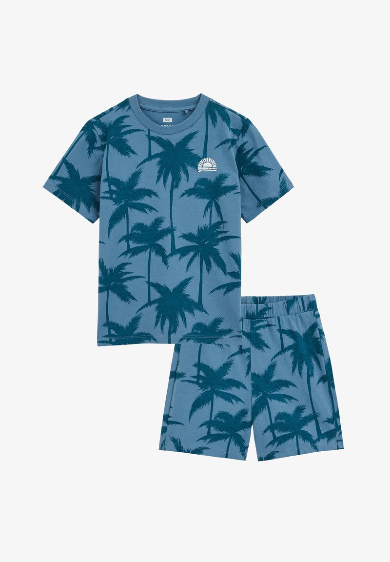 Ensemble de vêtements d'intérieur deux pièces pour enfants en coton bleu avec un motif de palmiers. Chemise à manches courtes et short avec une ceinture élastique.
