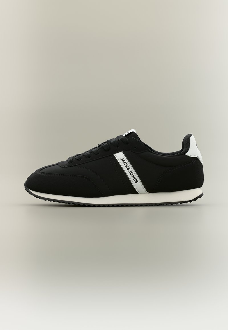 Black low-top sneaker with white sole and heel tab, white side stripe branded "Jack & Jones," and black laces, shown in side profile.