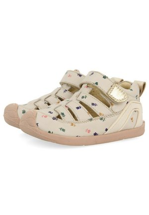 Sandalias de color claro con un patrón floral, correas de velcro ajustables, puntera redondeada, plantilla acolchada y suela de goma.