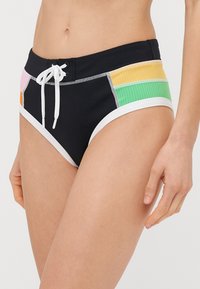 Czarne szorty kąpielowe z wielokolorowymi panelami bocznymi w odcieniach różowym, pomarańczowym, żółtym i zielonym. Posiadają białą talie i detal z sznurkiem.