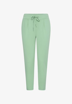 Light green tapered pants with elastic waistband and front drawstring, featuring subtle pleats near the hips.