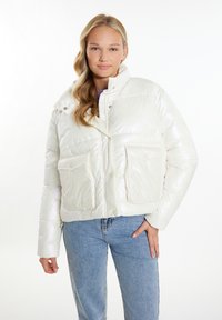 Hvid, blank pufferjakke med et cropped design, der har en høj krave, to frontlommer og en skinnende overflade, båret over blå jeans.