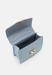 Světle modrá kabelka s krokodýlím vzorem z kůže, se zlatými kovovými detaily, obdélníkového tvaru, s klopou a vnitřním oddělením pro organizaci.