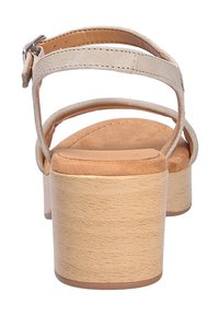 Tansandalen mit Plateauabsatz, beige Wildlederriemen und Knöchelverschluss. Mit einem blockförmigen Absatz mit Holzstruktur und einer weich gepolsterten Fußbett.