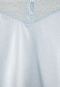 Light blue sleepwear featuring a lace yoke, three buttons, and a smooth satin-like texture. Simple design with a relaxed shape.