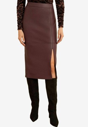 Burgundy faux leather pencil skirt with a high slit, flat seams, and a smooth texture, paired with black knee-high boots.