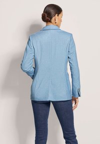 Hellblaues Blazer mit strukturiertem Stoff, taillierte Passform und Reverskragen. Verfügt über lange Ärmel und einen Ein-Knopf-Verschluss.