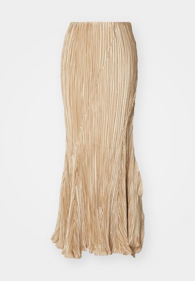 Raukšlėtas šviesiai rudas maksimalus sijonas su išsiplėtusiu apvadu, lengvas audinys ir sklandi tekstūra su subtiliu blizgesiu.