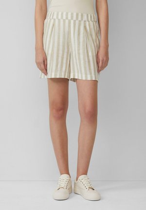 Linen blend shorts with vertical beige and white stripes, pleated front, elastic waist, paired with cream sneakers.