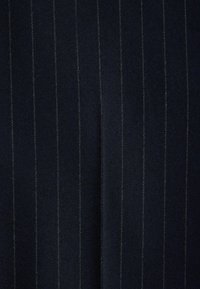 Navy fabric with vertical pinstripes in a contrasting color, featuring a smooth texture and uniform shape, suitable for formal wear.