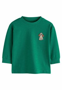 Camicia verde in cotone a maniche lunghe con collo a girocollo ribadito e design di un cane ricamato sul petto. Presenta maniche leggermente voluminosi.