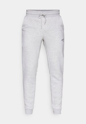 Gray fleece joggers with a drawstring waist, tapered leg design, side pockets, and small black logo detail on the left thigh.