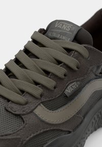 Vans Ultrarange sneakers feature a brown and olive fabric upper, textured mesh, flat laces, and a rubber sole with a distinctive tread pattern.