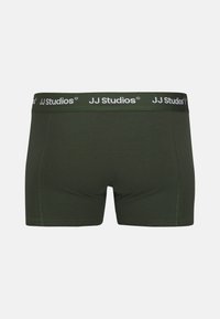 Dark green cotton boxer shorts with a JJ Studios branded elastic waistband, featuring a smooth texture and no visible patterns or accents.