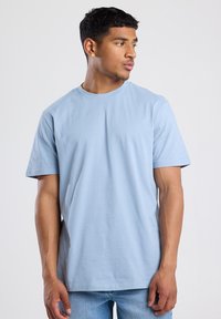 Light blue short-sleeve t-shirt in soft cotton fabric, featuring a classic crew neck and a relaxed fit. No visible patterns or accents.