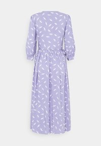 Lila klänning med prickigt mönster och vita fjädermotiv. Har trekvartslång ärm och knytning i midjan för justerbar passform.