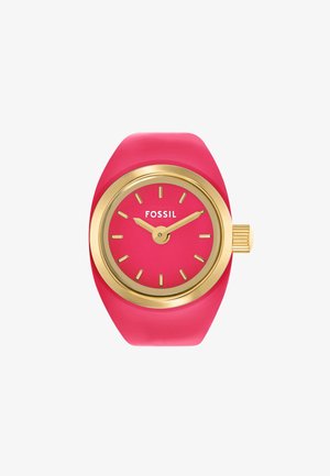 Fossil watch with a pink silicone strap, gold case, and a pink dial featuring bold hour markers and a crown. Simple design, modern aesthetic.