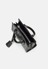 Black leather handbag with a crocodile texture, featuring two handles, a zippered compartment, and a decorative tag. Open view shown.