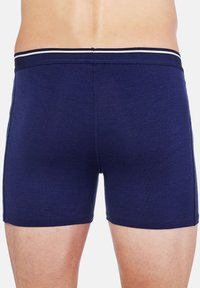 Navy blue boxer shorts made of a soft fabric, featuring a white striped waistband and a fitted design, with smooth texture and clean seams.
