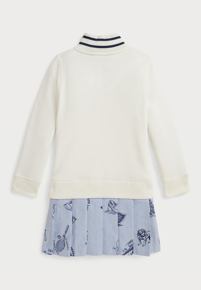 Sudadera blanca con cuello acanalado, rayas marinas y una falda plisada azul claro con un patrón de animales y artículos deportivos.