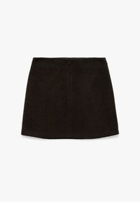 Ruskean tweed mini-hame, jossa on muotoiltu malli, hienovarainen tekstuuri ja piilotettu takavetoketju. Siistit linjat ja etutaskut.