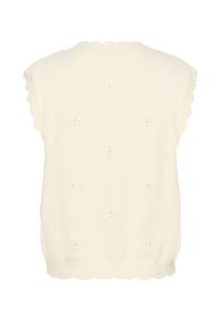 Kreemi värvi koesöödav, ilma varrukateta sviiter, millel on soonik serv ja laineline ääreosa. Kaunistatud väikeste dekoratiivsete õmblustehnikatega.