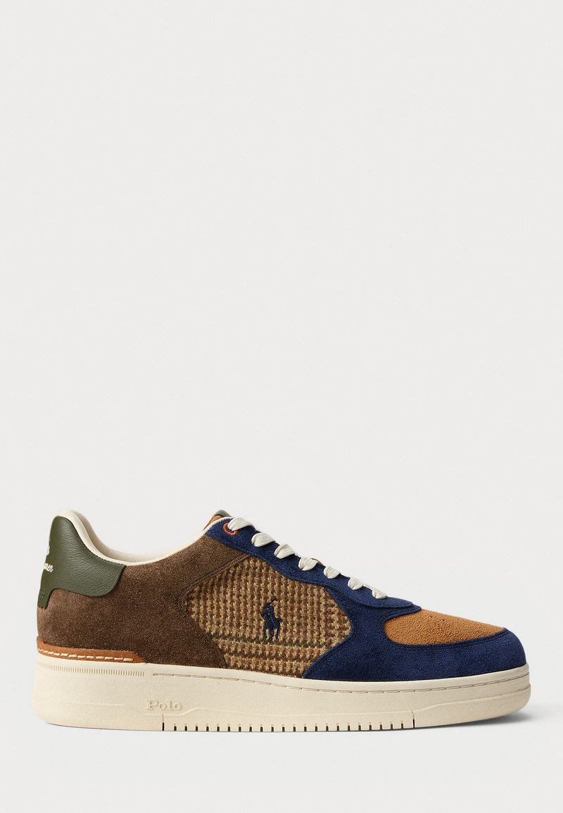 Men's sneaker featuring a mix of brown, navy, and tan suede, textured detailing, white laces, and a contrasting green heel accent.