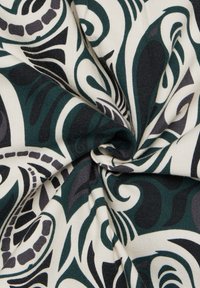Fabric with swirling patterns in dark green, black, and gray on a light cream background, showing smooth texture and intricate design.