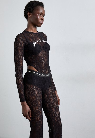 Black lace bodysuit with long sleeves and cut-out sides; features "Palm Angels" logo in white. Textured lace pattern throughout.
