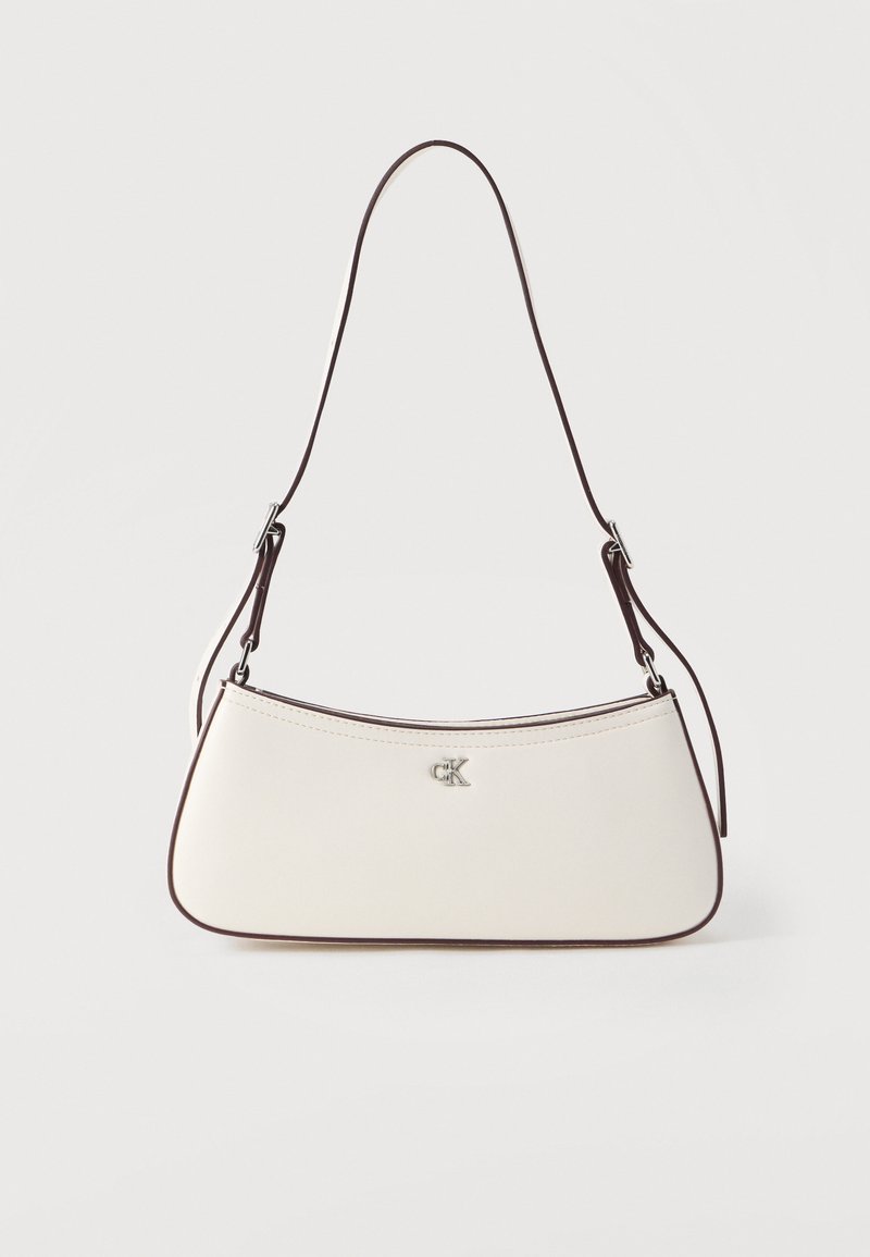 Λευκή δερμάτινη τσάντα χειρός με καμπυλωτό σχήμα, καφέ διακοσμητικό περίγραμμα και ασημί λογότυπο. Διαθέτει λεπτό, ρυθμιζόμενο ιμάντα ώμου.