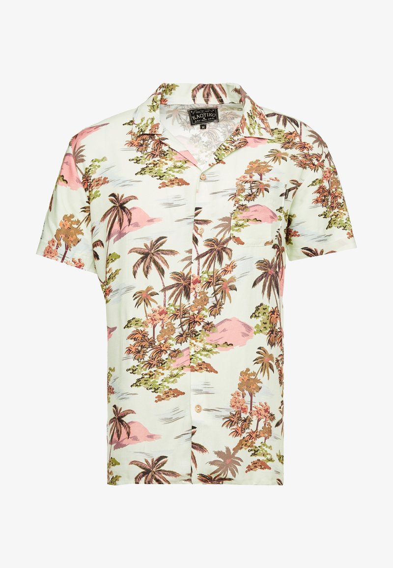 Chemise à manches courtes boutonnée avec motif tropical de palmiers et île en marron, vert et rose sur fond clair.