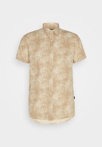 Chemise à manches courtes avec des boutons en beige ornée d'un motif de feuille de palmier. Fabriquée en tissu léger au toucher doux et avec un ourlet arrondi.