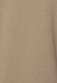 Light brown fabric with a smooth, soft texture, featuring a consistent pattern and no visible seams or distressing.