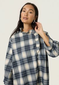 Soaked in Luxury Blouse - navy checks