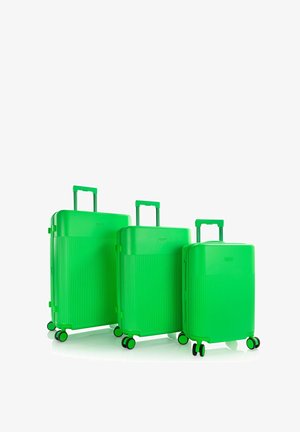 Drei leuchtend grüne Hartschalenkoffer in verschiedenen Größen mit ausgezogenen Griffen und vier Rollen vor weißem Hintergrund.
