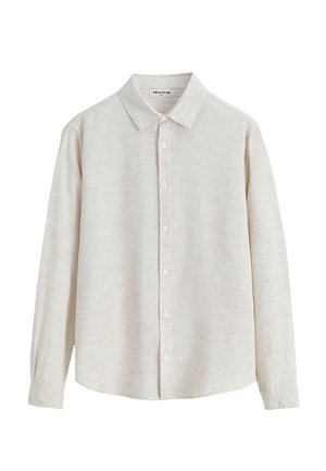 Chemise beige à manches longues, boutonnée, avec un col et un motif texturé subtil, présentée sur fond blanc.