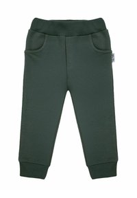 Ciemnozielone spodnie dresowe wykonane z miękkiego materiału, z elastycznym pasem, dwoma bocznymi kieszeniami i zwężanymi mankietami przy kostkach.