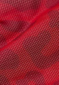 Red fabric with a textured pattern of small white dog silhouettes, showcasing a smooth surface and even weave.