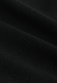 Fekete szövet, texturált felülettel, finom szőtt mintákkal. Az anyag tartónak tűnik és matt felületű.